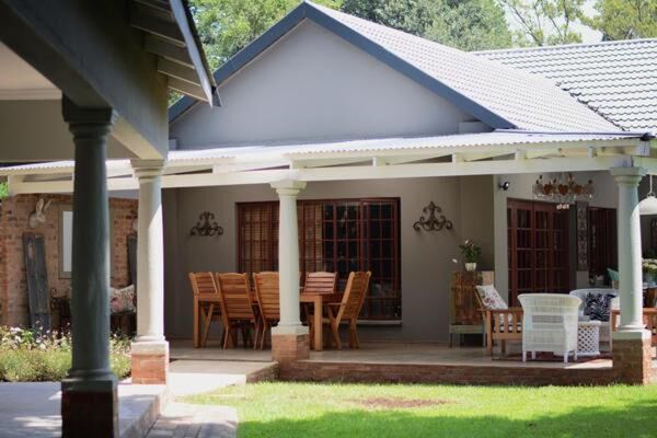 Covered terrace and garden at Dancing River Guesthouse, Vereeniging